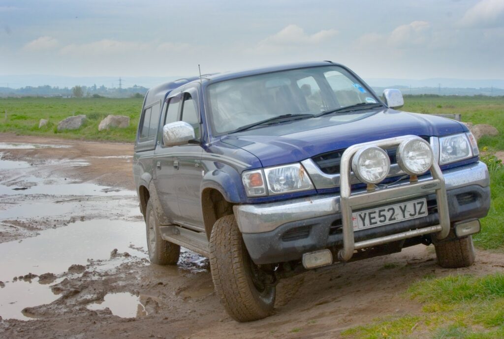 Blue 4x4 truck in mud